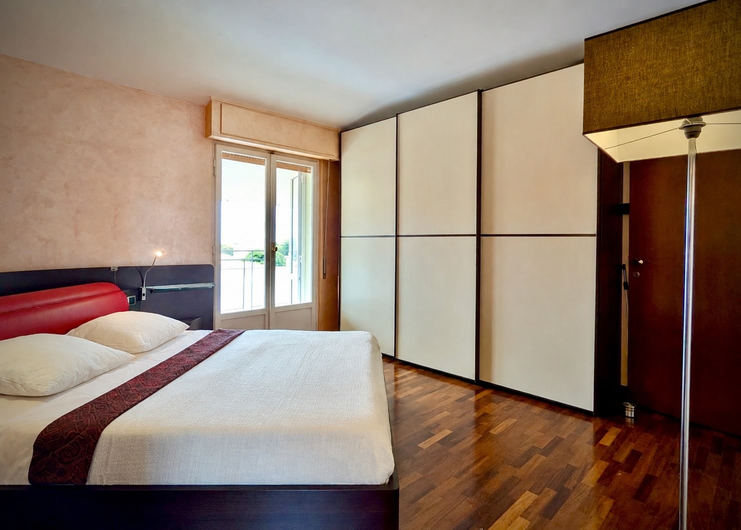 Double bedroom with built-in wardrobe and balcony access