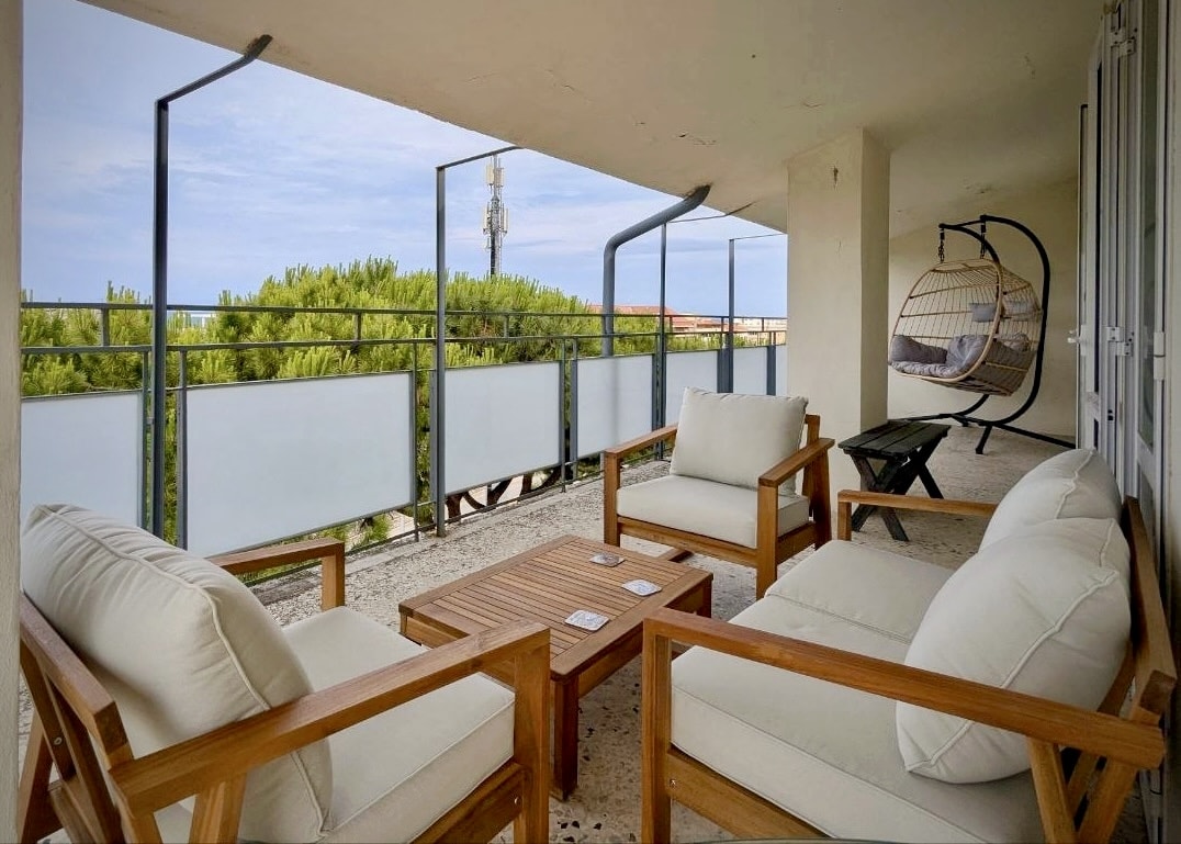 Sea-view side of the wrap-around balcony with lounge furniture